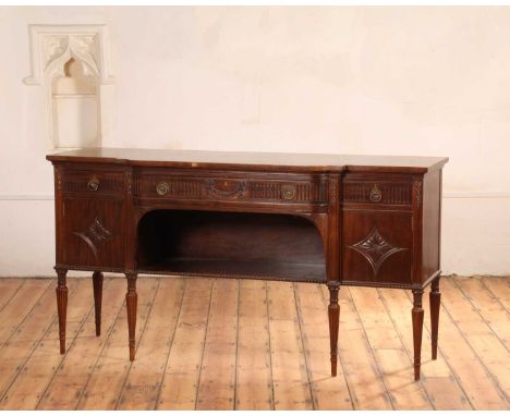 A mahogany breakfront sideboard, early 20th century, in the Adam taste, having a long central frieze drawer over an open shel