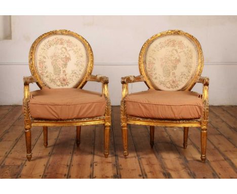 A pair of Louis XVI style carved giltwood armchairs, each having a tapestry upholstered back, h.98cm