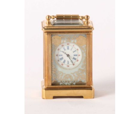A brass minuet carriage clock, inset with four enamel decorated porcelain panels, h.6 x w.4 x d.3cm
