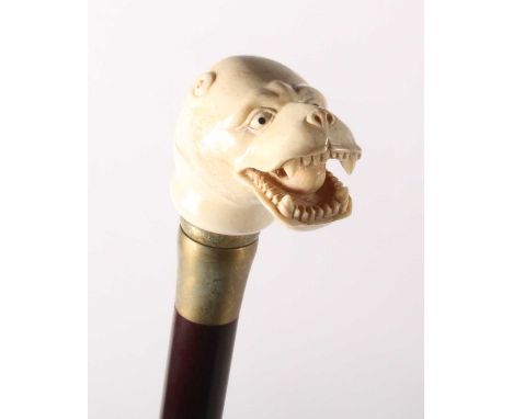 A walking stick, having a carved bone handle in the form of a leopard head, h.85cm