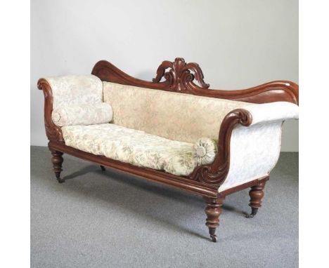 A carved mahogany sofa, 19th century, upholstered in cream, standing on turned legs, w.197cm, seat d.54cm