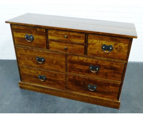 A Laura Ashley stained hardwood sideboard / chest, the rectangular top above an arrangement of eight drawers, on plinth base