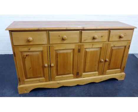 A pine low dresser base with four short drawers above four cupboard doors, 84 x 153cm 