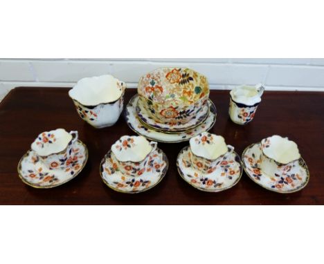 A Staffordshire porcelain teaset painted in Imari pallet with flowers and foliate comprising four cups, four saucers, four si