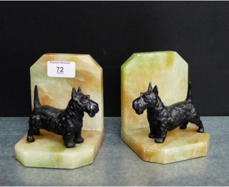 A pair of Art Deco hardstone bookends mounted with black painted Spelter Scottie Dogs, 12cm high, (2) 