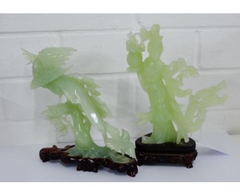 Two pale green carved jade figures, one of a female figure the other of birds, both on hardwood stands, tallest 21cm, (2) 