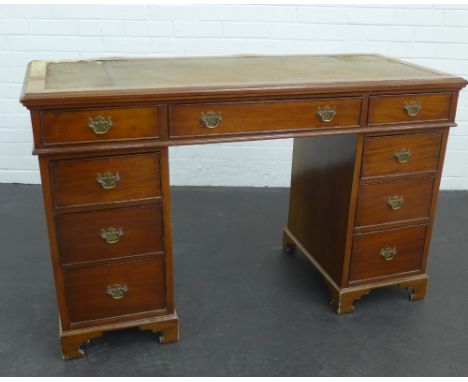 A mahogany desk with leather skivver and  central frieze drawer,  flanked by four graduating short drawers, 80 x 127cm (a/f) 