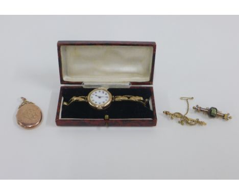 Two early 20th century 9ct gold brooches and a lady's vintage 9ct gold cased wristwatch on a 9ct gold expanding strap and a 9