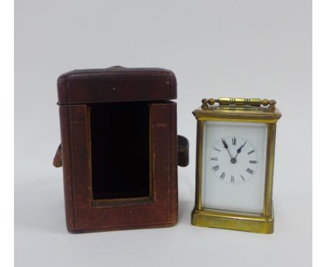French brass and glass panelled carriage clock, with leather carry case, and key, 15cm high including handle 