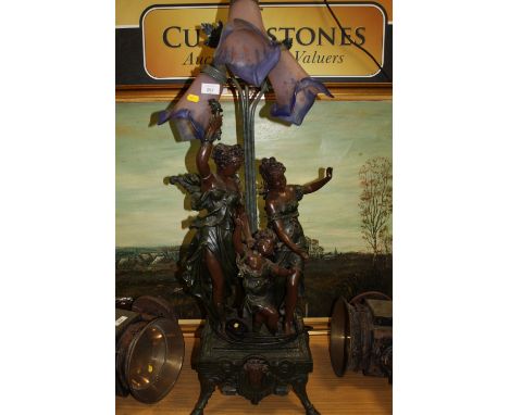 A LARGE THREE BULB FIGURATIVE LAMP WITH FLORAL GLASS SHADES