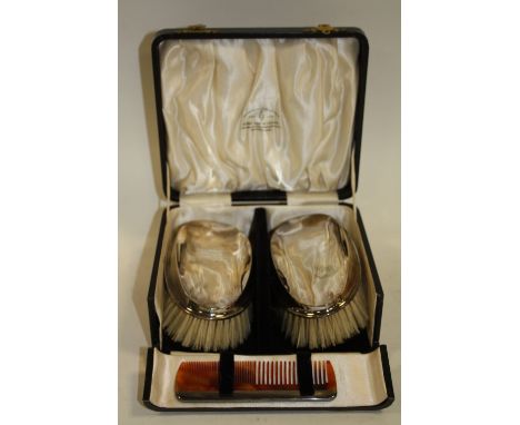 A CASED HALLMARKED SILVER BRUSH AND COMB SET 