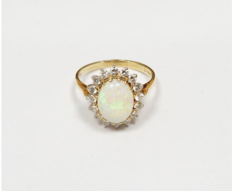 18ct gold, opal and diamond cluster ring, the oval opal surrounded by claw set diamonds, 3.7g approxCondition ReportOpal appe