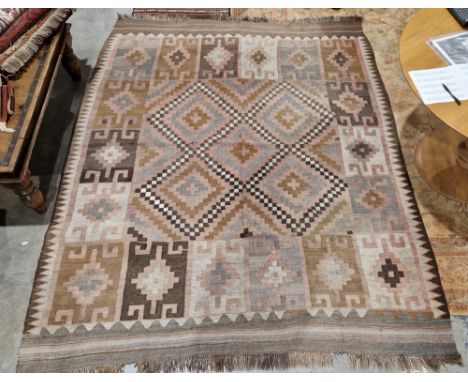 Large pink ground rug with central stepped 'X' shaped panel to single geometric border, 250cm x 202cm