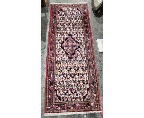 Iranian cream ground wool runner&nbsp;with central geometric medallion on floral and stylised bird field, single geometric bo