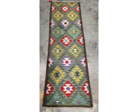 Maimana kilim runner, 217cm x 68cm&nbsp;, having allover geometric filled lozenge decoration in green, red and blue&nbsp;