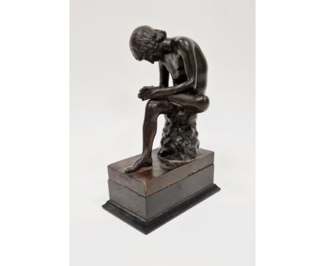 Bronze figure of a seated young nude male , looking at the sole of his left foot, blindstamp foundry mark on the top of the b