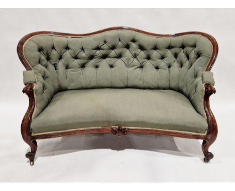 Victorian mahogany-framed parlour sofa, with scroll button back and foliate carved frame, upholstered in green fabric, on scr