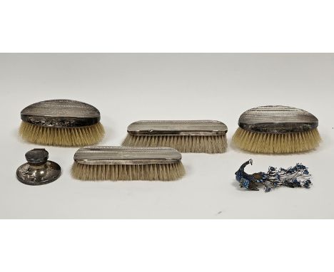 Silver-backed dressing table brush set comprising two pairs of brushes, monogrammed and with engine-turned decoration, an ena