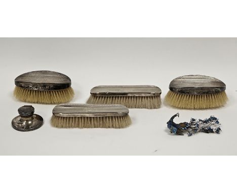 Silver-backed dressing table brush set comprising two pairs of brushes, monogrammed and with engine-turned decoration, an ena