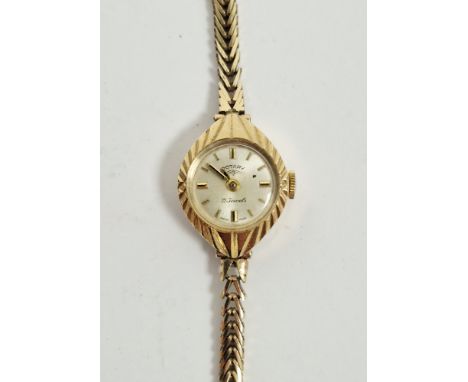 Lady&rsquo;s Rotary 9ct gold wristwatch, the circular face with engraved case, on integral herringbone-pattern strap, 15g app