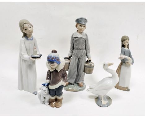 Collection of Lladro figures comprising a girl with candlestick, a boy holding two pails, a boy beside polar bear, a girl car