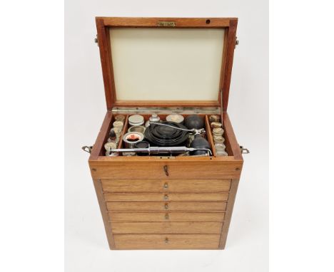 Table top cabinet, fitted with raised lid and drawers below containing a quantity of vintage Dentist equipment and accessorie