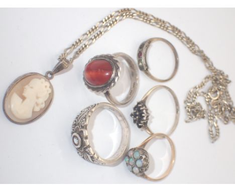 Five silver rings including opal set example and a silver pendant