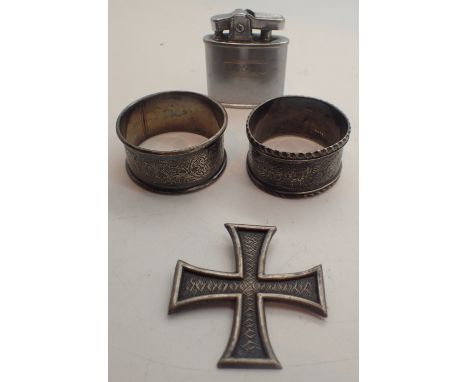 Two silver napkin rings a white metal cross and a lighter