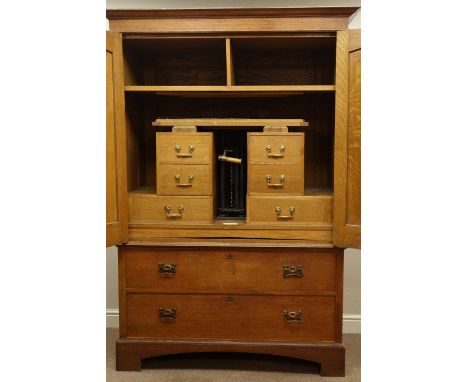 Shapland and Petter 'The Lever Wardrobe' early 20th century oak clothes press, two arch top panelled doors with Art Nouveau d