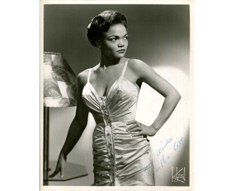 KITT EARTHA: (1927-2008) American singer and actress. Vintage signed 8 x 10 photograph of Kitt standing in a three-quarter le