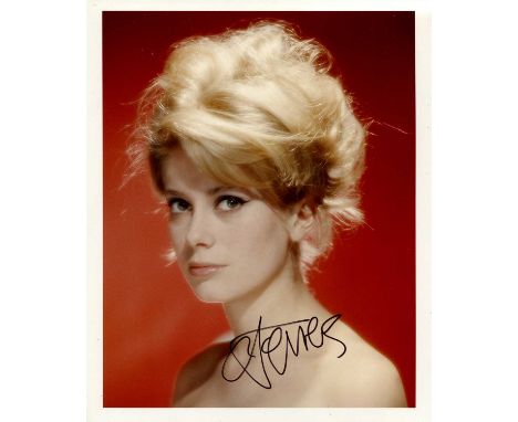 DENEUVE CATHERINE: (1943- ) French actress. Signed colour 8 x 10 photograph, an attractive study of the young actress in a he