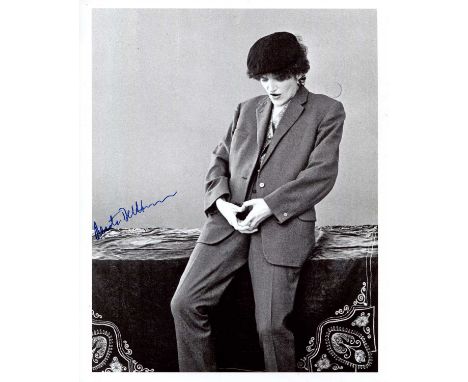 BERTLMANN RENATE: (1943- ) Austrian feminist avant-garde artist. Signed 8 x 10 photograph of Bertlmann standing in a sexually