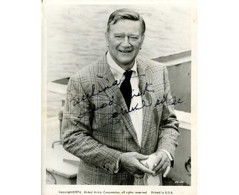 WAYNE JOHN: (1907-1979) American actor, Academy Award winner. Signed and inscribed 8 x 10 photograph of Wayne standing outdoo