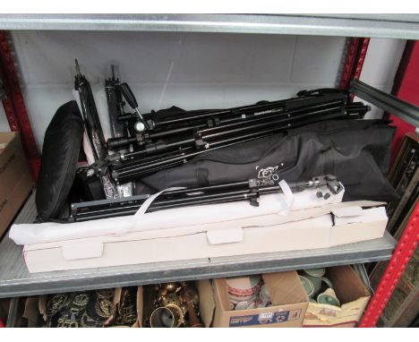 A selection of photographic studio equipment including lighting reflectors, collapsible photo booth, backdrop stands, lightin