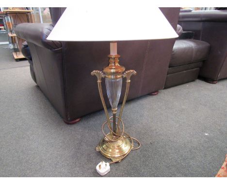 A modern brass effect and glass lamp with shade 