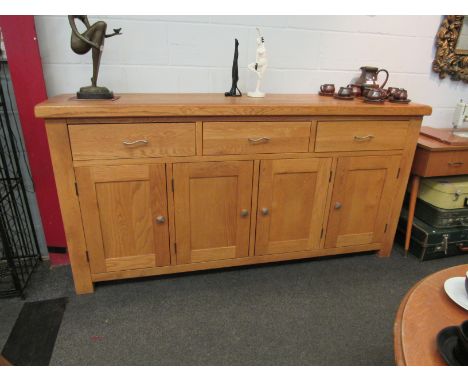 A light oak sideboard, three drawers over four doors, 100cm x 200cm x 45cm 