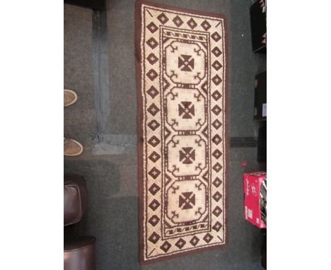 A small woollen rug with matching runner 