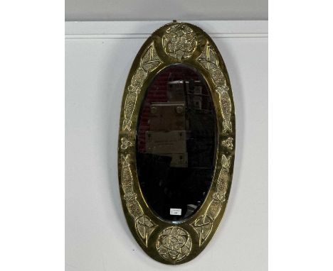 ARTS & CRAFTS BRASS FRAMED OVAL WALL MIRROR, EARLY 20TH CENTURY with Celtic knots against hammered grounds in relief41cm x 85