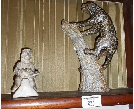 Carved stone leopard on tree, and 19th c. ceramic artisan figure