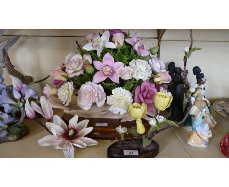 A Boehm ceramic posy mounted on a hardwood plinth and two other Boehm posies.