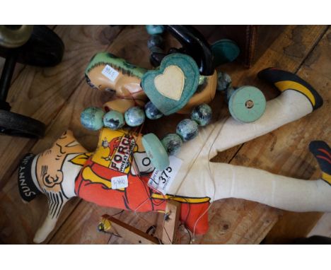 A vintage Sunny Jim advertising soft toy, and a painted wooden string puppet.