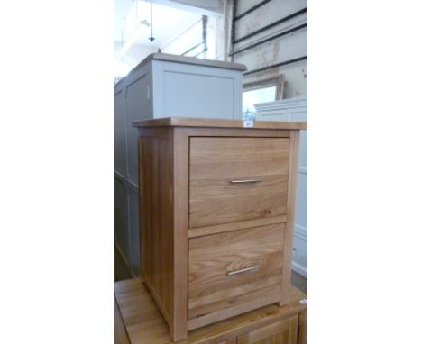 A good quality light oak bedside cabinet with two drawers.