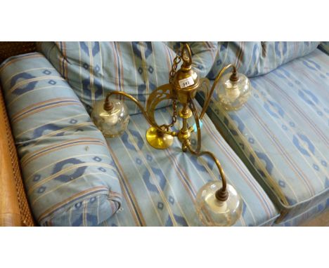 An early 20th Century brass three branch ceiling light fitting with S shaped arms.