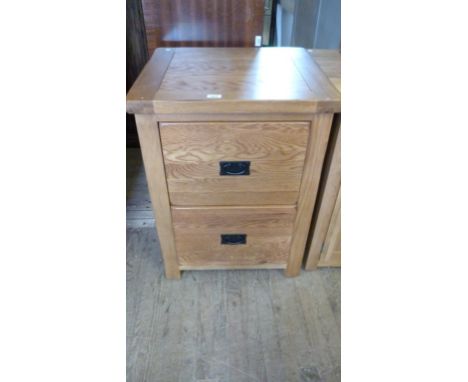 A good quality light oak finished bedside cabinet with two drawers.
