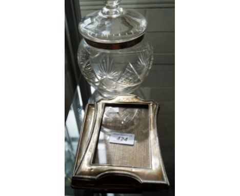 Two early 20th Century silver easel photograph frames and a silver mounted cut glass bulbous biscuit barrel (3).