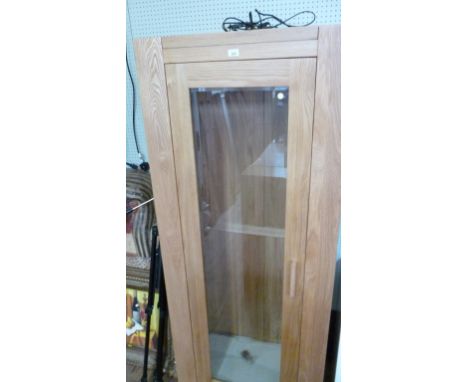 A good quality light oak tall bookcase with single glass door fitted interior lights and six glass shelves.