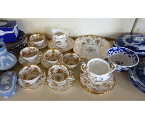 A Mintons gilt leaf and floral pattern part tea service comprising sandwich plate, milk jug, sugar basin, cups and saucers (2
