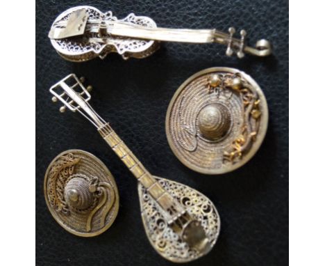 A filigree brooch in the form of a violin, a filigree brooch in the form of a mandolin, and two filigree brooches in the form