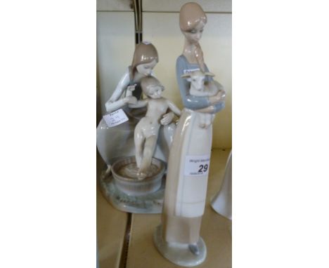 A Lladro figure of a young woman holding a lamb and a Lladro group of a young woman bathing a young girl.