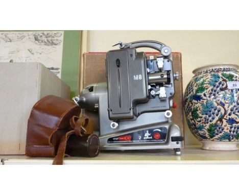 A cased vintage Bell & Howell cine camera and a boxed Bolex cine projector.